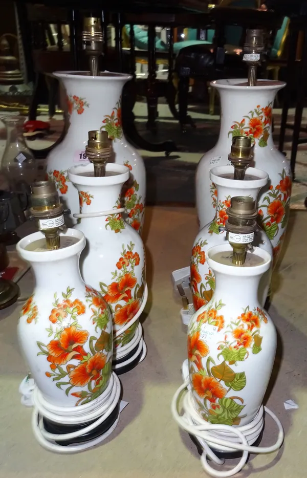 A set of six porcelain floral decorated table lamps, comprising three graduated pairs, (6).  S2