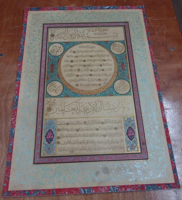 A Turkish Calligraphic panel (Hilyeh),  signed Ahmad Kamil, dated AH 1353/1934 AD, Arabic manuscript on paper laid on board, on a turquoise ground fil