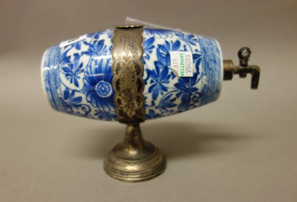 A Chinese blue and white barrel shaped flask, Kangxi, painted with flowers and adapted as a spirit cask and cover with later European engraved silver