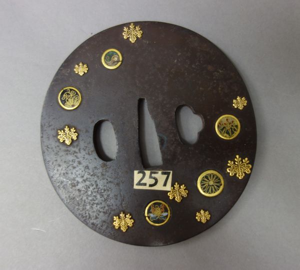 Three Japanese iron tsuba, Edo period, 19th century, comprising; an Hirata school tsuba, inlaid with cloisonné roundels depicting ying-yang and gilt p