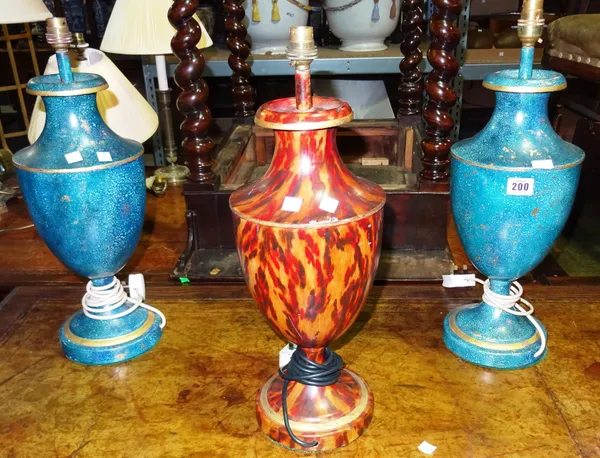 A pair of blue and gilt tole painted urn shaped table lamps and a similar lamp with faux tortoiseshell decoration, (3).  G4