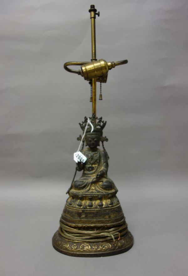 A Chinese gilt-bronze figure of Guanyin, probably Ming dynasty, the goddess seated with hands in dharmachakra mudra on a lotus base, five incised char