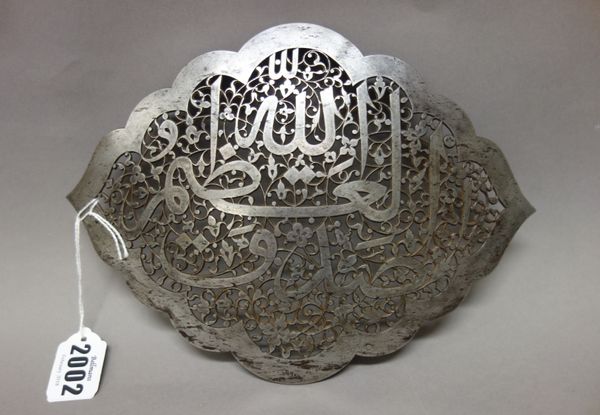 A Safavid cut-steel calligraphic panel, probably second half 16th century, of convex cusped form, the centre cut and pierced with the inscription, `Sa