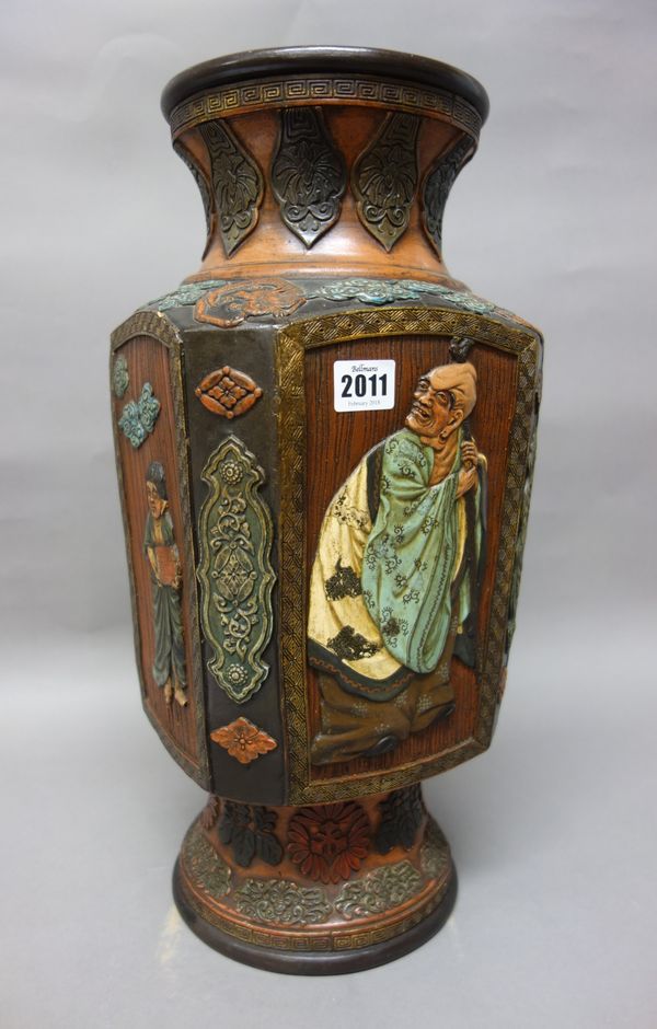 A Japanese terracotta vase, Meiji/Taisho period, of canted square section, each side decorated in relief with an arhat, oni or child, beneath a waiste