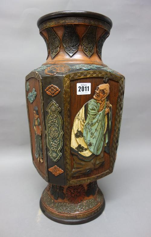 A Japanese terracotta vase, Meiji/Taisho period, of canted square section, each side decorated in relief with an arhat, oni or child, beneath a waiste