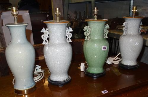 A pair of 20th century grey crackle glazed table lamps, a matching green lamp and one further green crackled lamp, (4).  J2