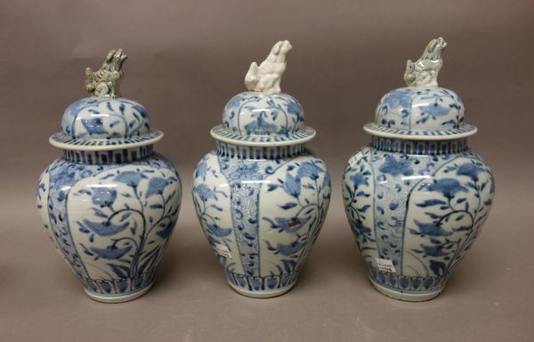 A Japanese Arita blue and white garniture, Edo period, 18th century, comprising; three baluster vases and covers and two beaker vases, each painted wi