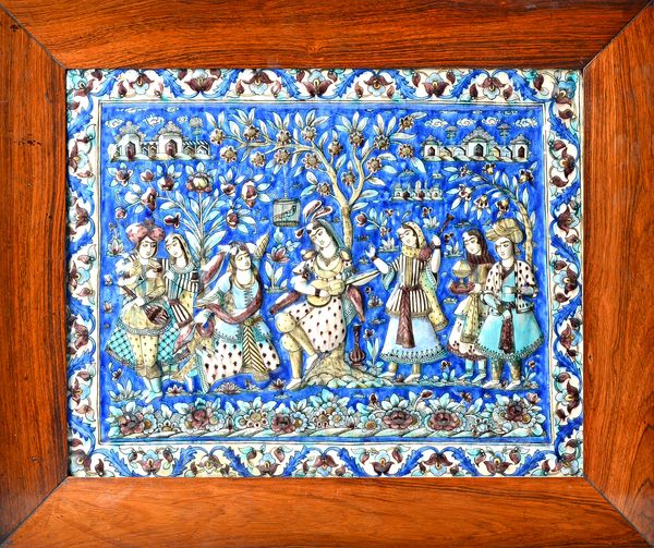 A large Qajar rectangular moulded pottery tile, Persia, late 19th, moulded and coloured with a musician seated beneath a tree, flanked by six other fi