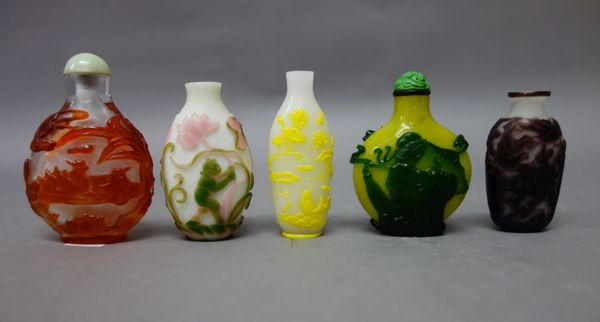 A Chinese green overlay yellow glass snuff bottle, late 19th/20th century, one side carved with a kneeling woman, the reverse with a man holding a fan