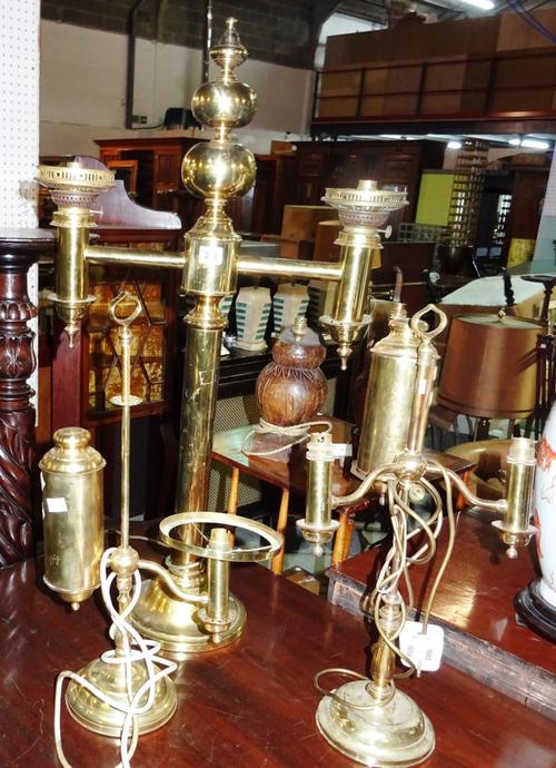 A large Colza style brass dual oil lamp and two further brass oil lamps, all later converted for electricity, (3).  G5