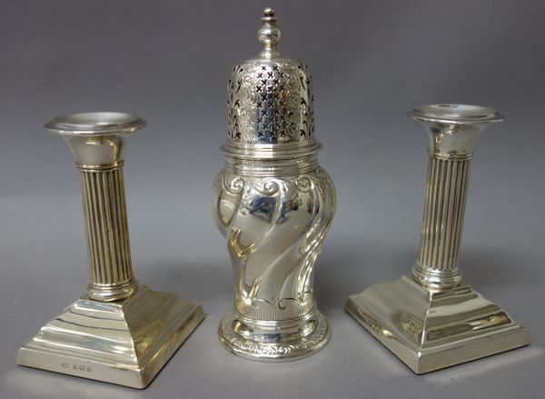 Silver, comprising; a Victorian sugar caster of pear shaped form, with spiral fluted decoration, raised on a decorated circular foot, height 16.5 cm,