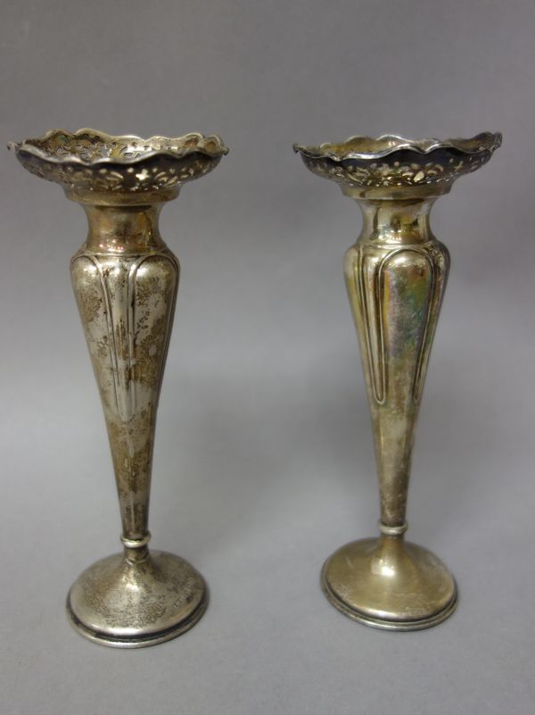 Silver and silver mounted wares, comprising; a pair of trumpet shaped vases, each with pierced decoration to the rim, raised on a loaded circular foot