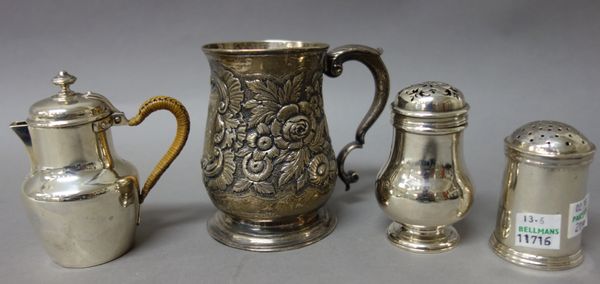 A George II silver mug, of baluster form, with later floral and foliate embossed decoration, London 1754, height 10cms, an Irish pounce pot, of cylind