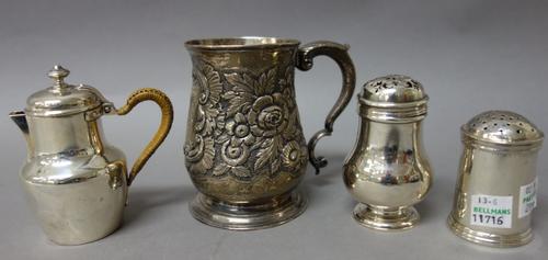A George II silver mug, of baluster form, with later floral and foliate embossed decoration, London 1754, height 10cms, an Irish pounce pot, of cylind