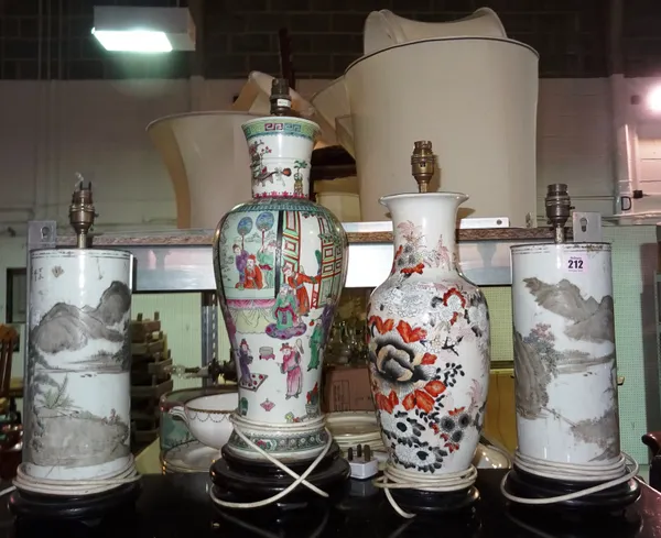 A pair of Asian cylindrical table lamps, decorated with landscape and script and two further Asian lamp bases, (4).  F4