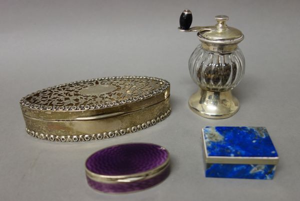 A silver pot pourri box, of oval form with pierced decoration to the hinged lid, within floral moulded rims, Birmingham 1912, a glass pepper mill, the