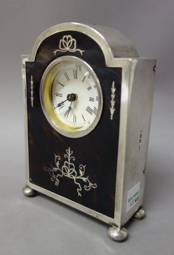 A silver and tortoiseshell mounted rear winding mantel clock, the circular dial with Roman numerals and with blued steel hands, the case front with in