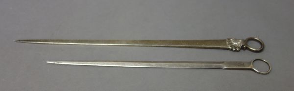 A George III silver skewer, with a ring and shell handle, length 33.5cm, London 1773 and a William IV silver skewer, with a ring handle, length 27.5cm