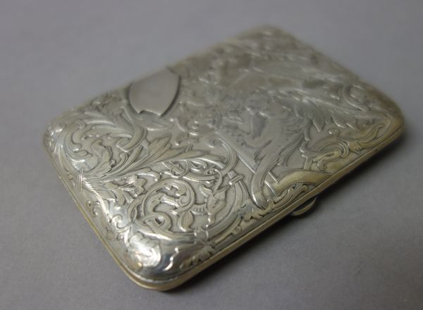 A French rectangular cigarette case, the exterior decorated with scrolls and mythological animals.  Illustrated