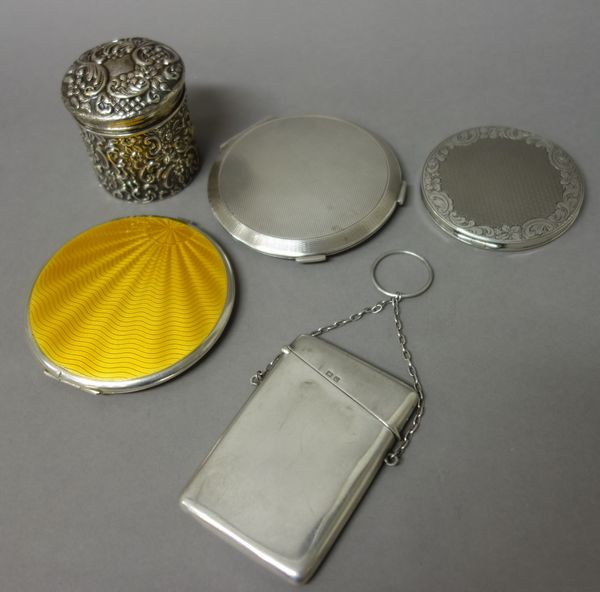 Silver and silver mounted wares, comprising; a circular powder compact, the hinged cover with yellow enamelled decoration, Birmingham 1933, another ci