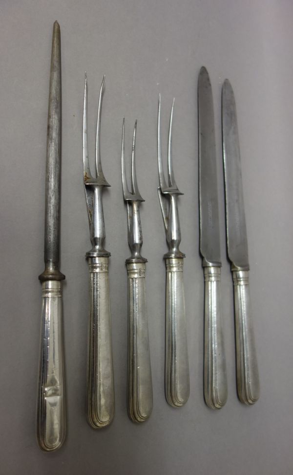 A silver handled five piece carving set, comprising; two carving knives, two carving forks and a steel, London 1913 and another silver handled carving