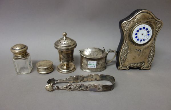 Silver and silver mounted wares, comprising; a small clock, Birmingham 1909, a glass smelling salts bottle, an oval mustard pot, the lid present, but