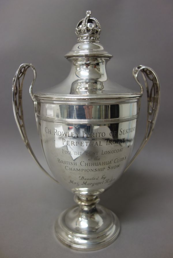 A silver twin handled trophy cup and cover, of urn shaped form, the handles pierced with the monogram ER V11, the detachable cover having a crown fini