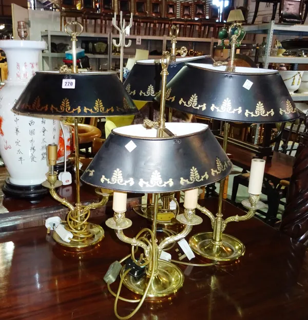 A group of four 20th century brass bouillotte style lamps with painted black tole shades, (4).  G5