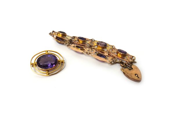 A gold, amethyst and gem set bracelet, in a pierced oval link design with a heart shaped padlock clasp, detailed 9 CT and a gold mounted amethyst sing