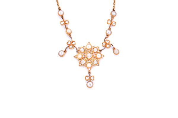 A gold, diamond and half pearl set necklace, the front with a central flowerhead shaped cluster, with a pendant drop at the front and with rose diamon