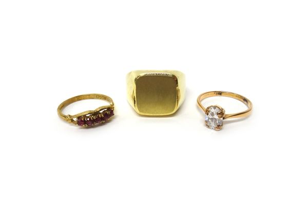 A gold and colourless gem set solitaire ring, a 9 ct gold signet style ring and a 9 ct gold and synthetic ruby set five stone ring, combined gross wei