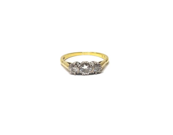 An 18ct gold and diamond set three stone ring, claw set with circular cut diamonds and with the principle diamond mounted at the centre, ring size N a