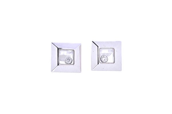 A pair of Chopard, white gold and diamond set ear studs, each of square form, glazed to the centre, with a circular cut loose diamond, the backs with