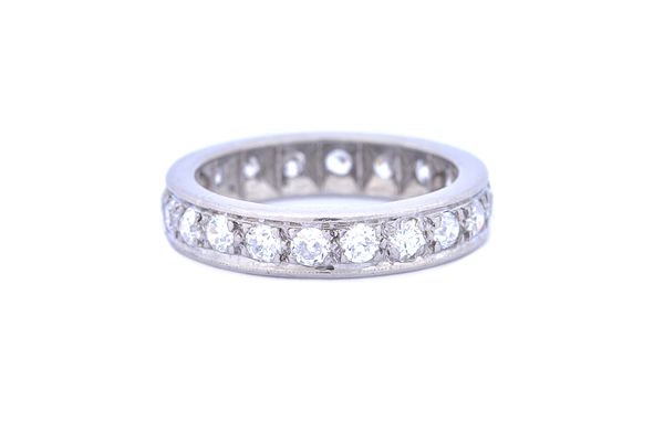 A diamond set full eternity ring mounted with cushion shaped diamonds, ring size M.  Illustrated