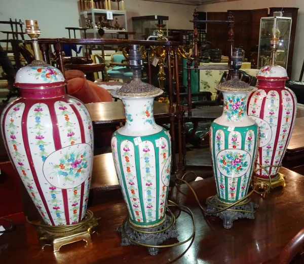 A pair of Sevres style burgundy and floral decorated table lamps and a pair of floral and green examples, (4).  F6