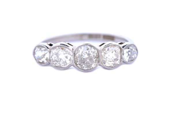 A white gold and platinum diamond set five stone ring, collet set with cushion shaped diamonds graduating in size to the centre stone, detailed 'W18ct