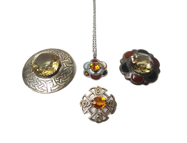 A Scottish Sterling silver and citrine set circular brooch with engraved Celtic style decoration, detailed 'Sterling Scotland', a silver mounted citri