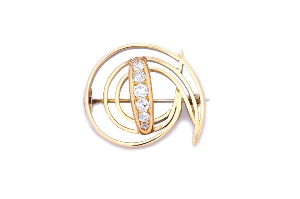 A gold and diamond set seven stone brooch, the centre in a curved design, mounted with a row of cushion shaped diamonds graduating in size to the cent