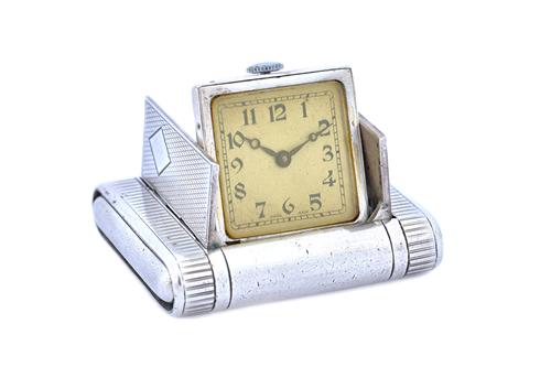 A silver rectangular cased folding purse watch, the square dial with black Arabic numerals and detailed 'Swiss Made', the case exterior with engine tu
