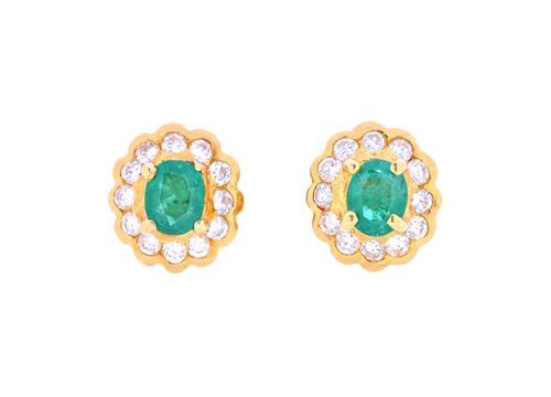 A pair of gold, emerald and diamond cluster earstuds, each claw set with an oval cut emerald, with a surround of circular cut diamonds, the backs with