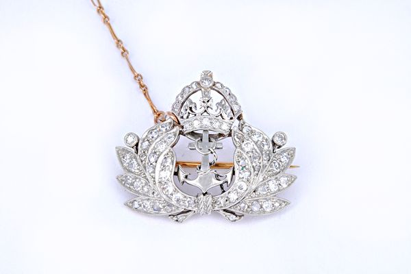 A diamond brooch, designed as the crowned anchor and wreath badge of The Royal Navy, mounted with cushion shaped and rose cut diamonds, fitted with a
