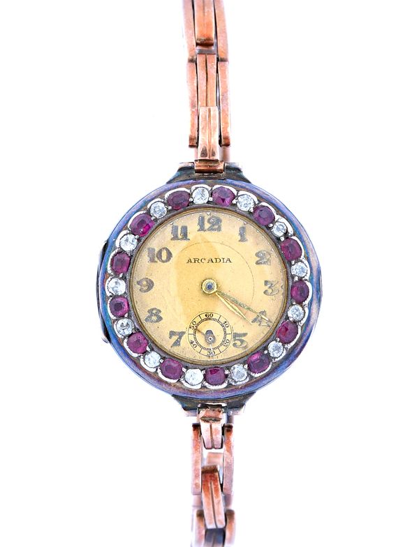 An Arcadia lady's 9ct gold, ruby and diamond set circular cased dress wristwatch, with an unsigned jewelled movement, the signed dial with gilt Arabic