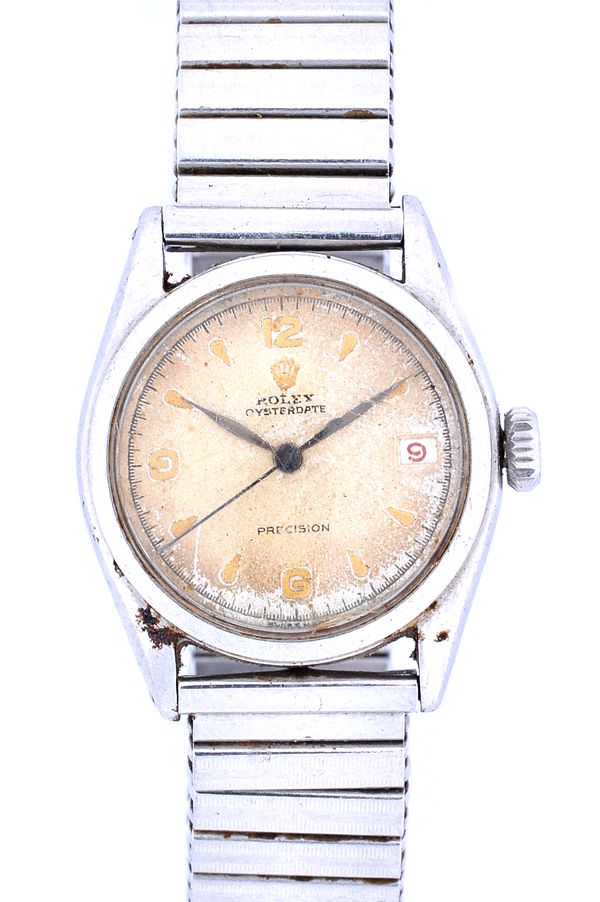 A Rolex Oysterdate steel circular cased gentleman's wristwatch, the signed silvered dial with gilt Arabic and arrow shaped numerals, centre seconds an