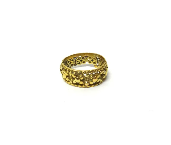 A gold band ring, pierced in a beaded floral design, apparently unmarked, ring size P, (damaged), weight 6.5 gms.