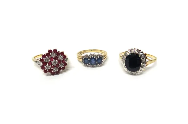 A 9ct gold, ruby and diamond ring, in a multiple cluster design, a 9ct gold, sapphire and diamond set oval cluster ring and a 9ct gold ring, claw set
