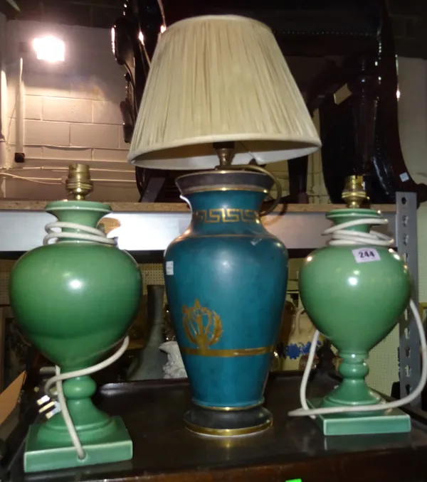 A pair of green pottery table lamps and a blue and gilt table lamp, (3).  I3