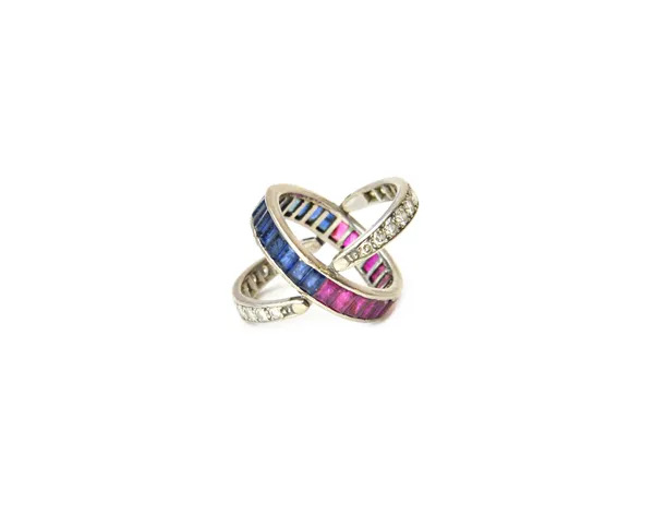 A diamond, ruby and sapphire set night and day swing over and under eternity ring, the principle band mounted with calibre cut rubies to one side and