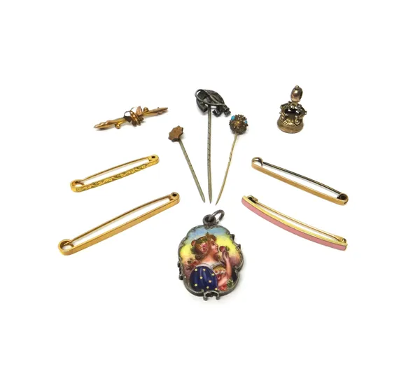 An enamelled pedant locket, the front decorated with a lady with a flower, a cornelain set small seal, a bar brooch with a butterfly motif, a pink ena