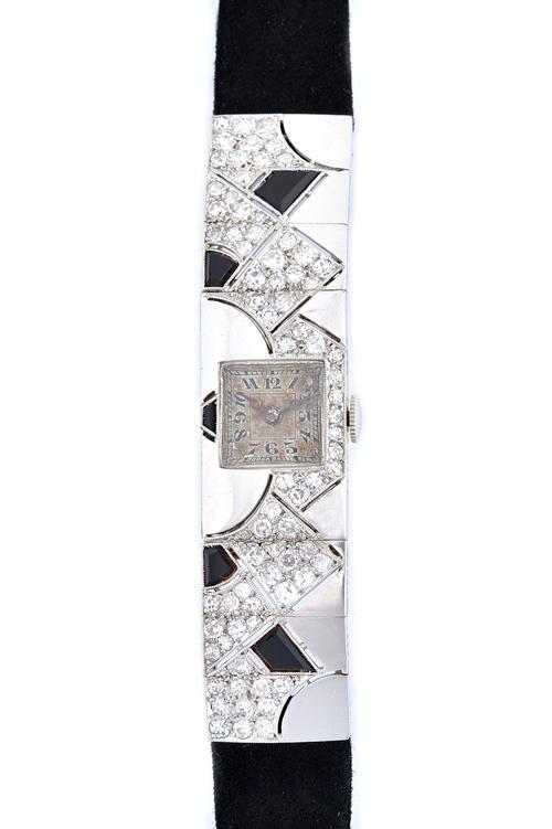 A French diamond and black onyx set Art Deco lady's dress wristwatch, with an unsigned oval jewelled movement, the square silvered dial with black Ara