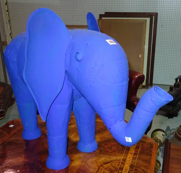A 20th century blue painted tin elephant 73cm wide x 55cm high and a red painted metal cockerel on stone stand, (2).  E3